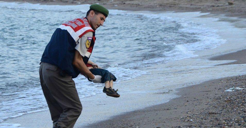 A paramilitary police officer carries the lifeless body of three-year-old Aylan Kurdi after he drowned when the boat he and his family members were in capsized near the Turkish resort of Bodrum early Wednesday, Sept. 2, 2015. (Photo: Nilüfer Demir/DHA)