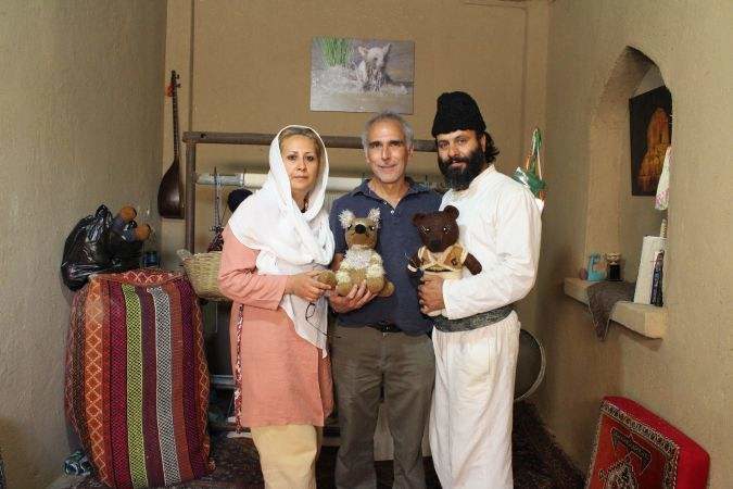 Image: Courtesy of Larry Cohler-Esses Larry Cohler Esses with Aghamir Miri and his wife, holding replicas of the bears they want to protect.