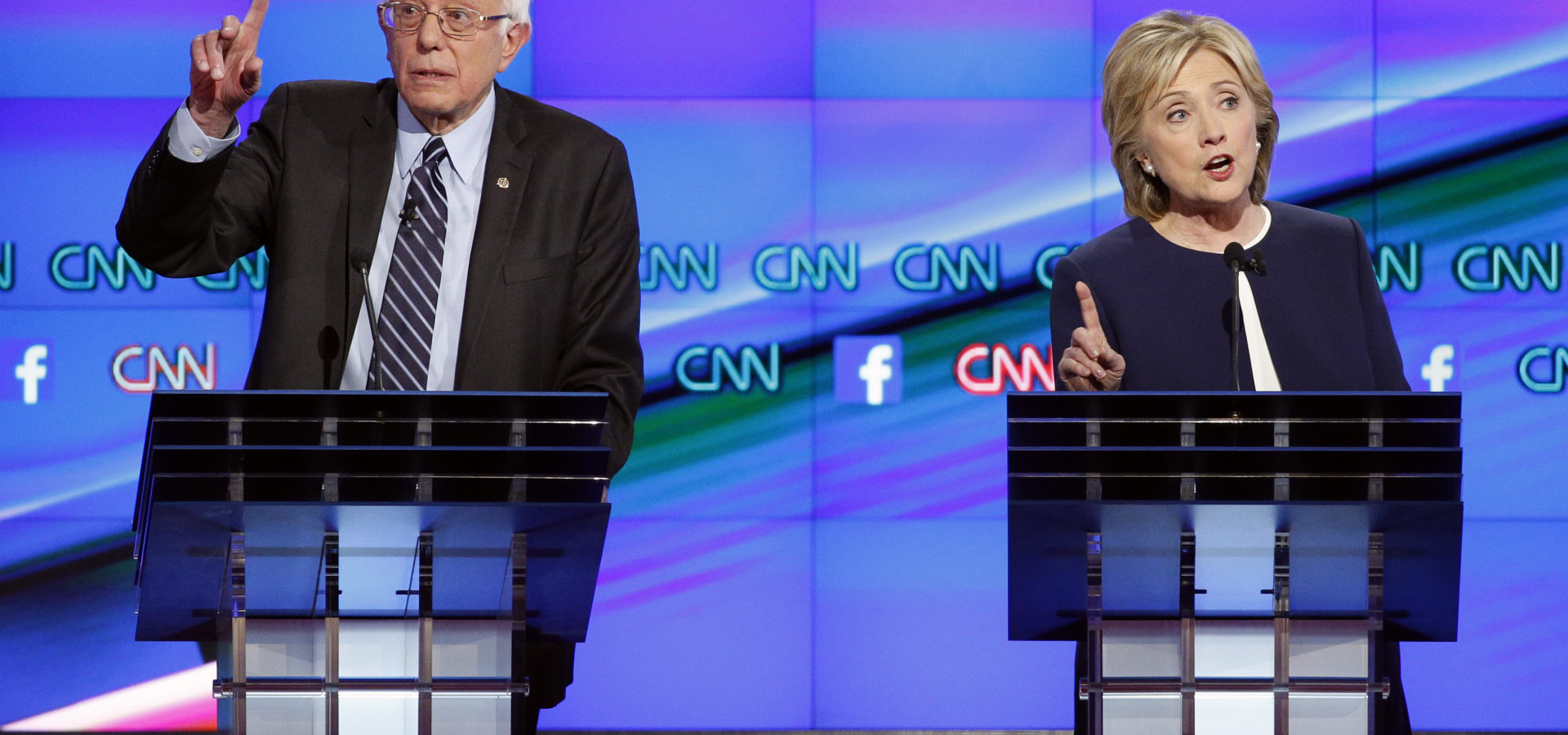 Hillary Rodham Clinton, right, and Sen. Bernie Sanders, of Vermont, speak during the CNN Democratic presidential debate Tuesday, Oct. 13, 2015, in Las Vegas. (AP Photo/John Locher)