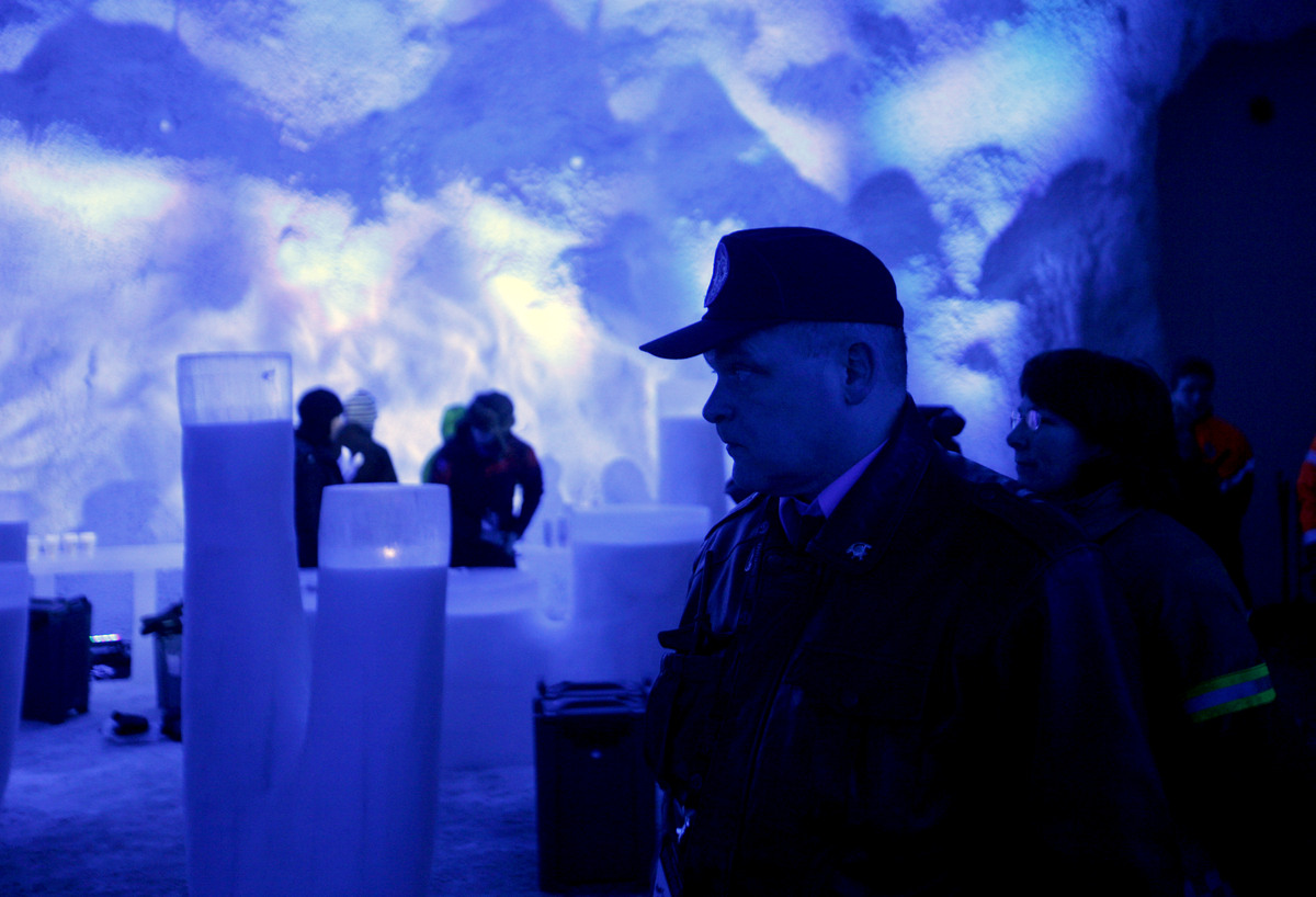 A police officer, foreground right, looks on, as last minute preparations are made inside the Svalbard Global Seed Vault in Longyearbyen, Norway, Tuesday, Feb. 26, 2008. The "doomsday" seed vault built to protect millions of food crops from climate change, wars and natural disasters opened Tuesday deep within an Arctic mountain in the remote Norwegian archipelago of Svalbard. (AP Photo/John McConnico)