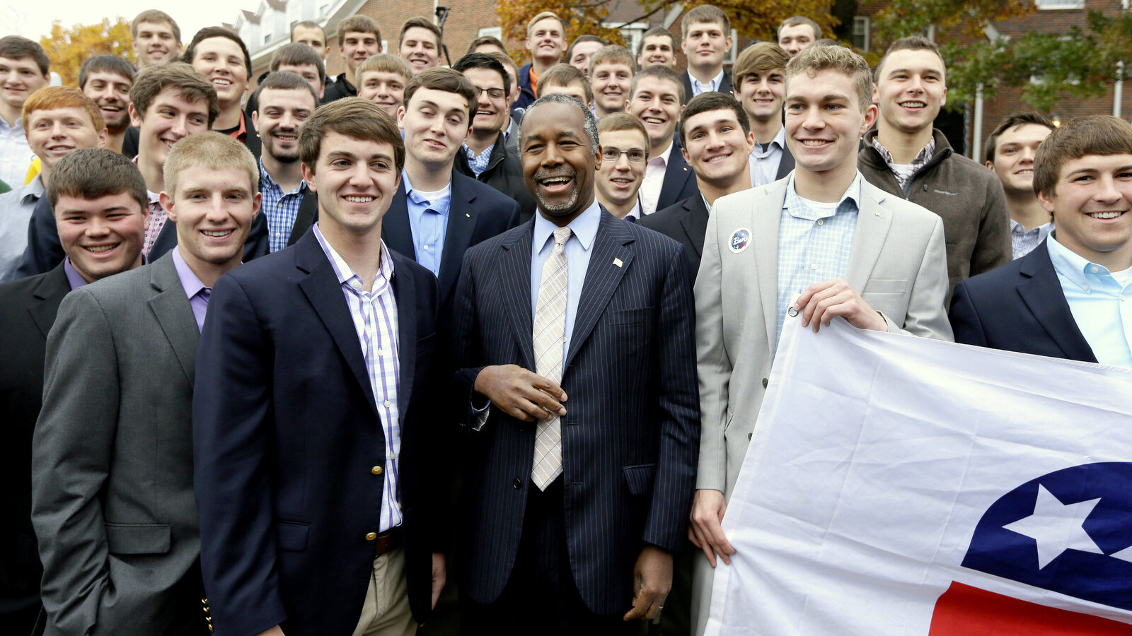 Republican presidential candidate Dr. Ben Carson poses for a photo with Alpha Gamma Rho fraternity members at Iowa State University following a campaign stop, Saturday, Oct. 24, 2015, in Ames, Iowa. (AP Photo/Charlie Neibergall)