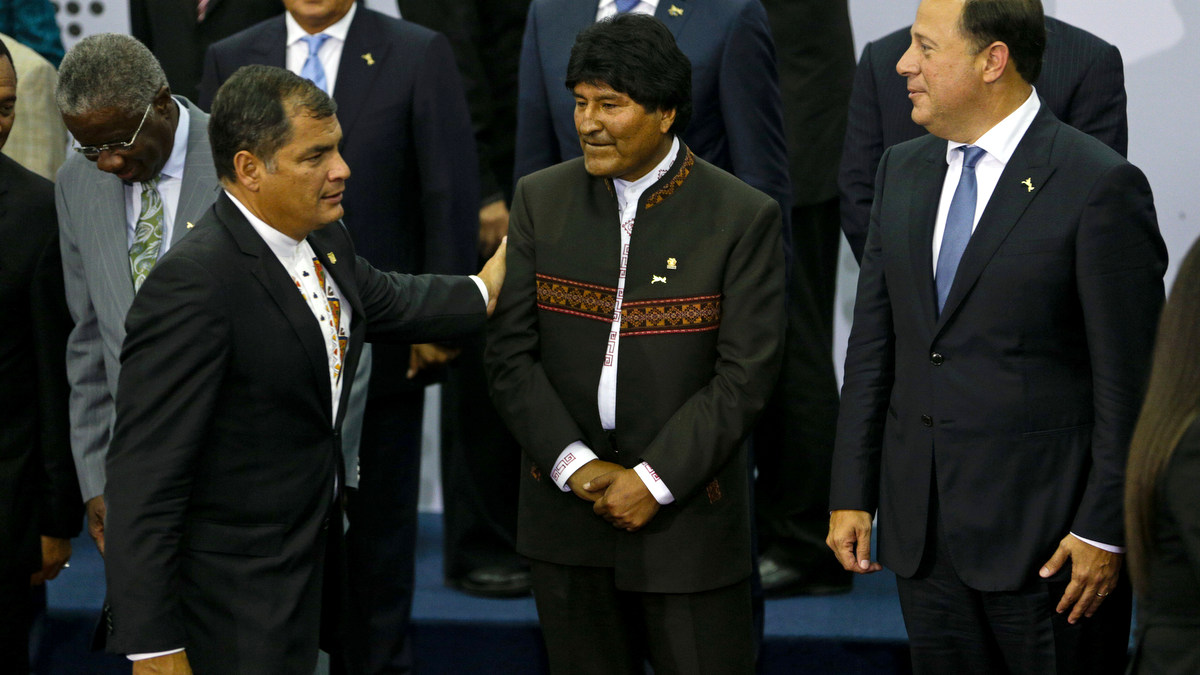 Ecuador's President Rafael Correa, left, greets Bolivia's President Evo Morales, center, and Panama's President Juan Carlos Varela as he arrives for the VII Summit of the Americas' official group photo, in Panama City, Panama, Saturday, April 11, 2015. (AP Photo/Arnulfo Franco)