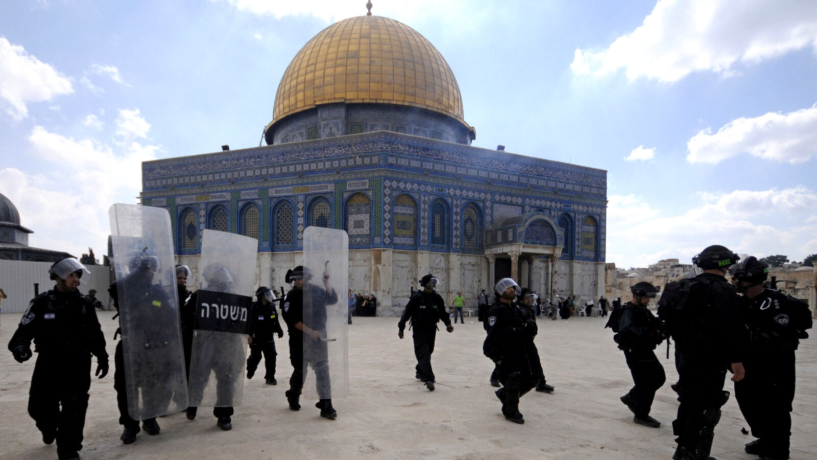 In this Friday, Oct. 5, 2012 file photo, Israeli forces take position during clashes with Palestinian worshippers at the Al-Aqsa Mosque compound in Jerusalem's Old City. A rectangular hilltop compound in Jerusalem is ground zero of the Israeli-Palestinian conflict. Known to Muslims as the Noble Sanctuary, it is Islam's third holiest spot and is home to an iconic golden-domed shrine. But to Jews it is the Temple Mount, their holiest place. This sensitive arrangement, and attempts to change it, lie at the heart of the unrest that rocked Jerusalem this week. (AP Photo/Mahmoud Illean)