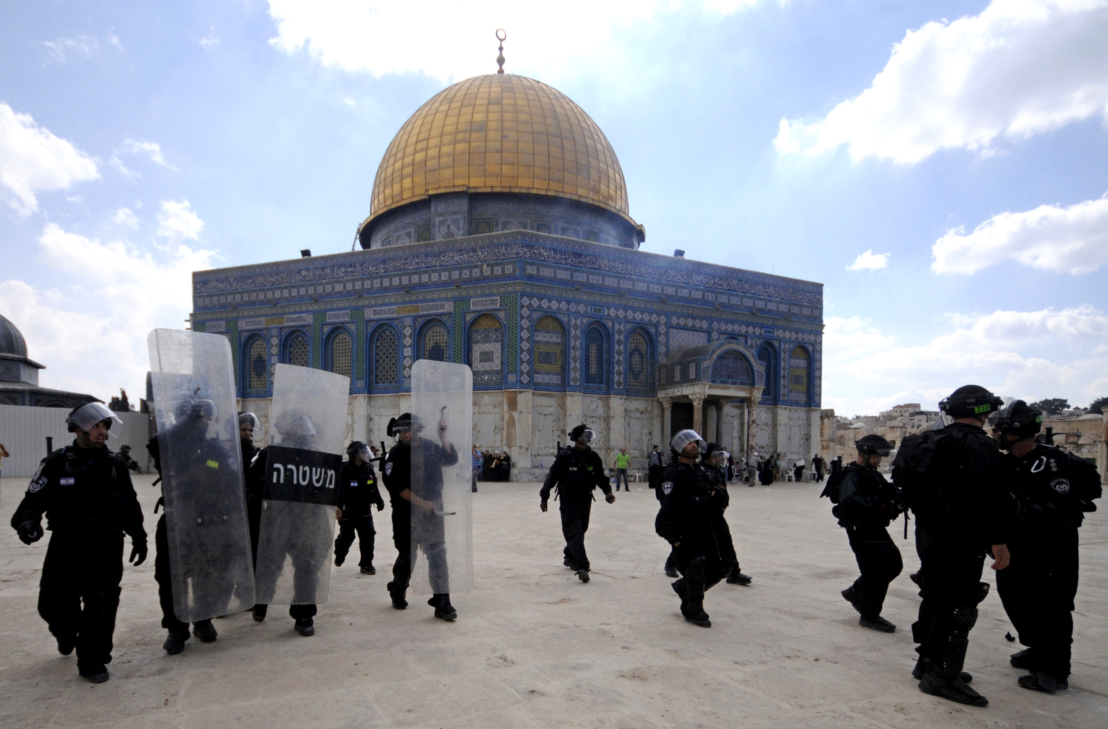 In this Friday, Oct. 5, 2012 file photo, Israeli forces take position during clashes with Palestinian worshippers at the Al-Aqsa Mosque compound in Jerusalem's Old City. A rectangular hilltop compound in Jerusalem is ground zero of the Israeli-Palestinian conflict. Known to Muslims as the Noble Sanctuary, it is Islam's third holiest spot and is home to an iconic golden-domed shrine. But to Jews it is the Temple Mount, their holiest place. This sensitive arrangement, and attempts to change it, lie at the heart of the unrest that rocked Jerusalem this week. (AP Photo/Mahmoud Illean)