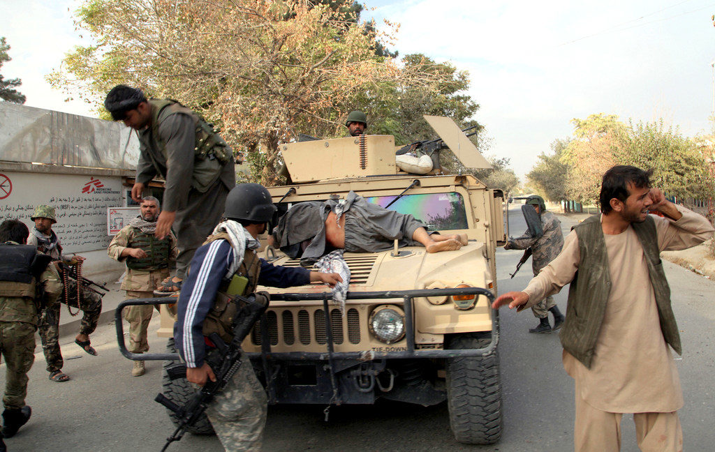 Afghan security forces take a wounded civilian man to the hospital after Taliban fighter's attack, in Kunduz city, north of Kabul, Afghanistan, Saturday, Oct. 3, 2015. Three staff from Doctors Without Borders were killed and 30 were missing after an explosion near their hospital in the northern Afghan city of Kunduz that may have been caused by a U.S. airstrike. (AP Photo/Dehsabzi)