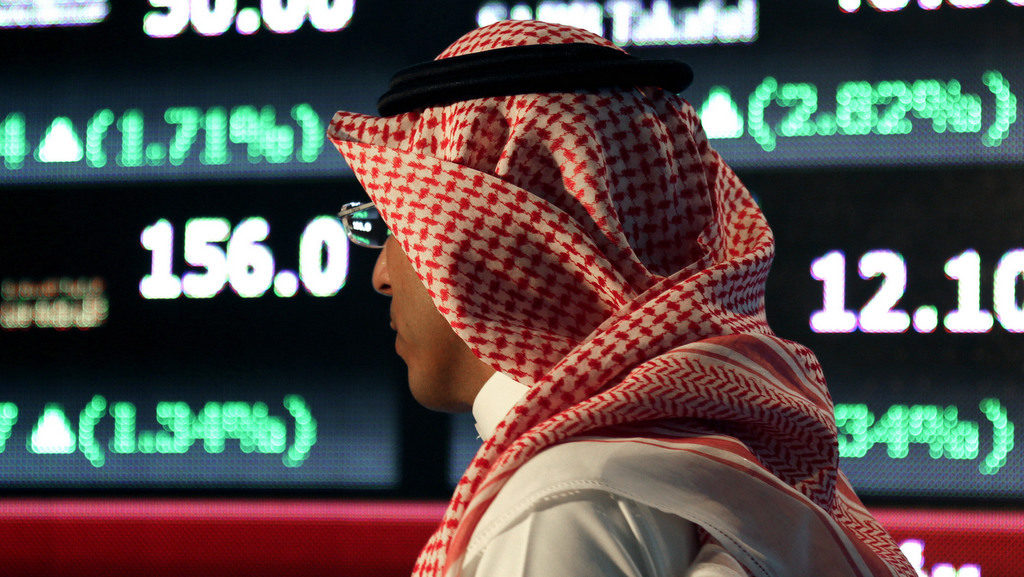 A Saudi man walks at the Tadawul Saudi Stock Exchange, in Riyadh, Saudi Arabia, Monday, June 15, 2015. Saudi Arabia's stock market, valued at $585 billion, opened up to direct foreign investment for the first time Monday, as the kingdom seeks an economic boost amid low global oil prices. (AP Photo/Hasan Jamali)