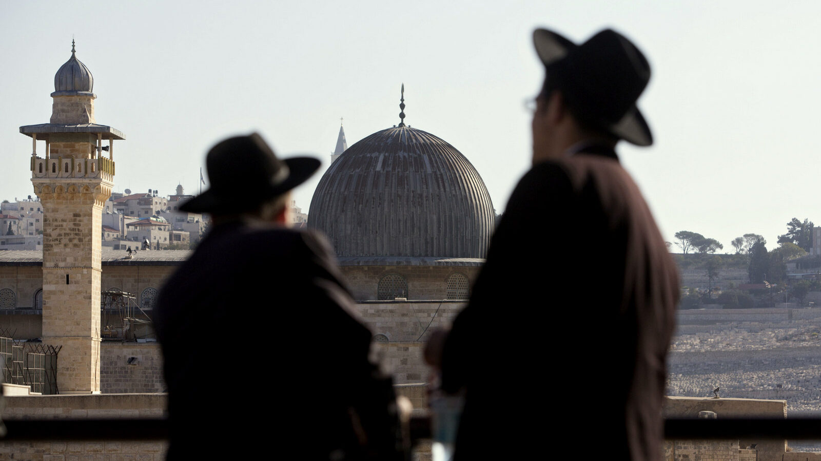 Ultra-Orthodox Jewish men stand in front of the Al-Aqsa Mosque in Jerusalem's Old City. Israeli police are reporting new unrest at Jerusalem's most sensitive holy site Sunday, Sept. 27, 2015. The site, known as the Temple Mount to Jews and the Noble Sanctuary to Muslims, had experienced several days of unrest in recent weeks. (AP Photo/Sebastian Scheiner, File)