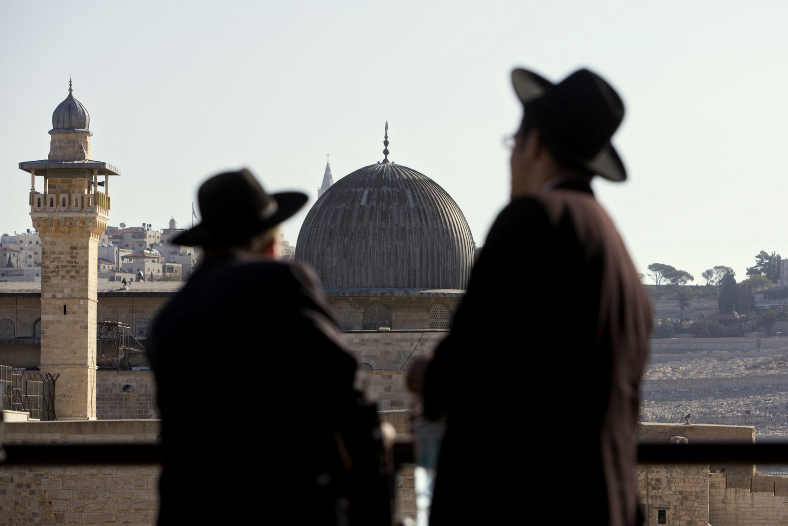 Ultra-Orthodox Jewish men stand in front of the Al-Aqsa Mosque in Jerusalem's Old City. Israeli police are reporting new unrest at Jerusalem's most sensitive holy site Sunday, Sept. 27, 2015. The site, known as the Temple Mount to Jews and the Noble Sanctuary to Muslims, had experienced several days of unrest in recent weeks. (AP Photo/Sebastian Scheiner, File)