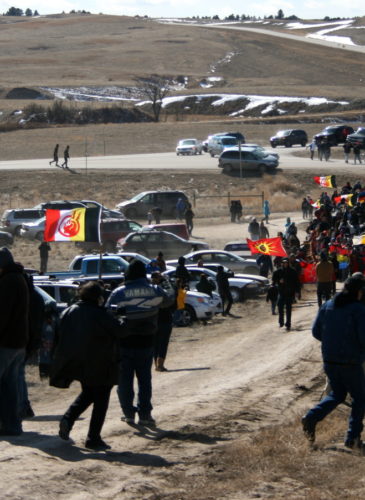 Members of the American Indian Movement walk to the Wounded Knee Massacre Monument Wednesday, Feb. 27, 2013 in Wounded Knee, S.D. (AP Photo/Kristi Eaton)