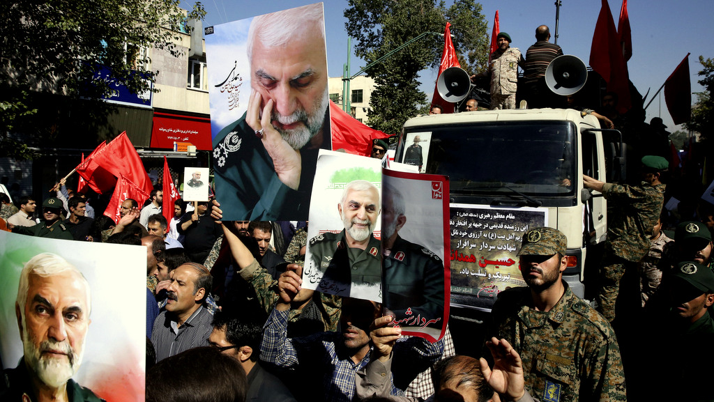 Iranians attend the funeral ceremony of Revolutionary Guard Gen. Hossein Hamedani, shown in the posters, in Tehran, Iran, Sunday, Oct. 11, 2015. Hamedani, a senior commander of the Guard, was killed by Islamic State extremists last week near the Syrian city of Aleppo, according to a state TV report. (AP Photo/Vahid Salemi)