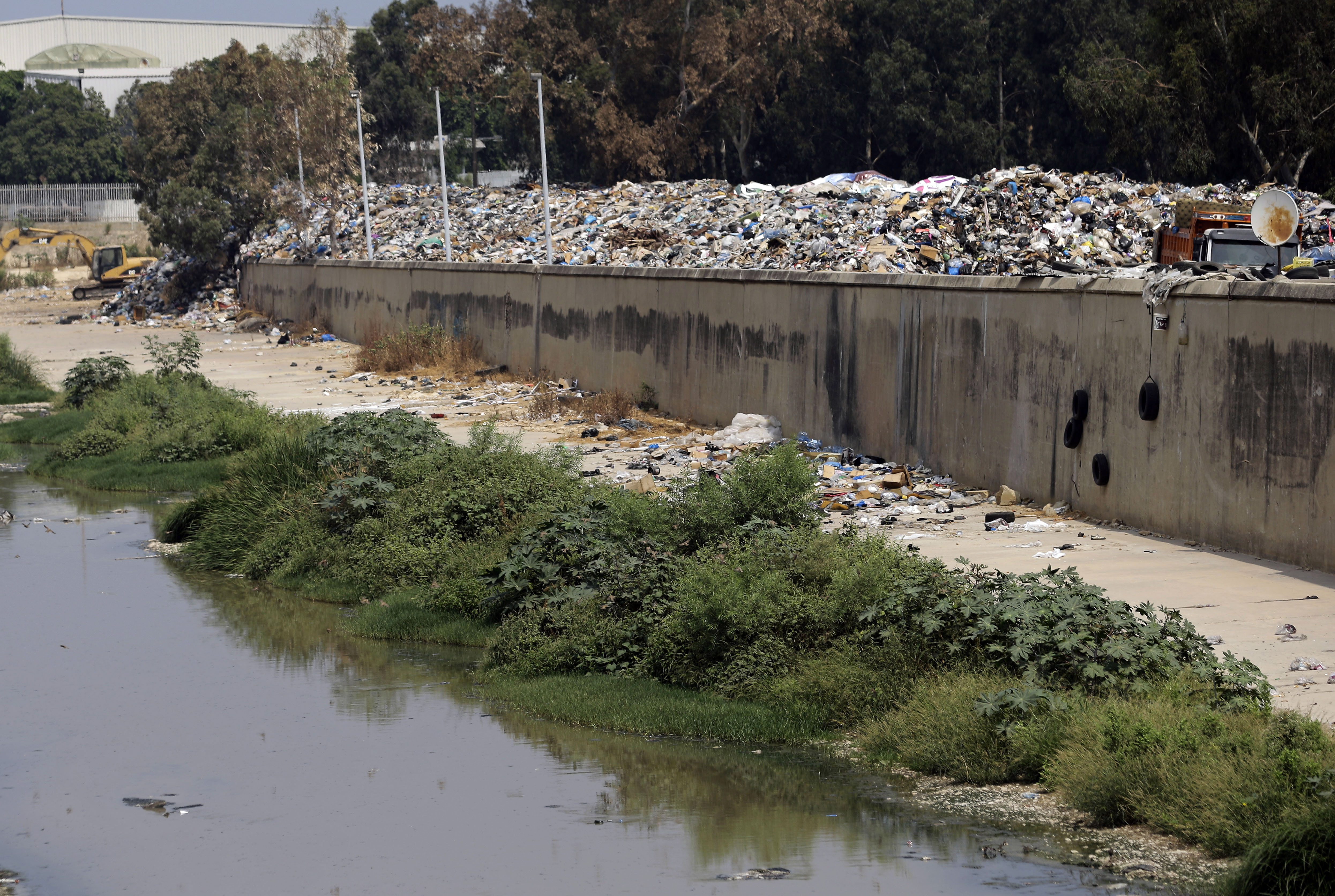 Garbage is piled on the bank of the Beirut River, in Beirut, Lebanon, Monday, Sept. 7, 2015. Lebanon has been witnessing a wave of anti-government rallies, sparked by the government's inability to solve an ongoing trash crisis. Those rallies have been led by civil society groups who came together to protest government corruption that led to the latest gridlock. (AP Photo/Hassan Ammar)