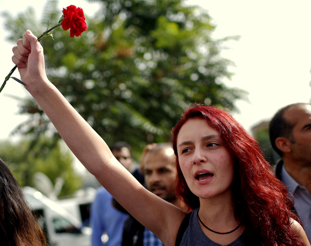 A woman participates at a memorial service for the victims of Saturday's attacks , at the site of the bombings in Ankara, Turkey, Monday, Oct. 12, 2015. The twin explosions Saturday ripped through a crowd of activists rallying for increased democracy and an end to violence between Kurdish rebels and Turkish security forces, killing dozens and injuring scores of others, in Turkey's deadliest attack in years. (AP Photo/Emrah Gurel)