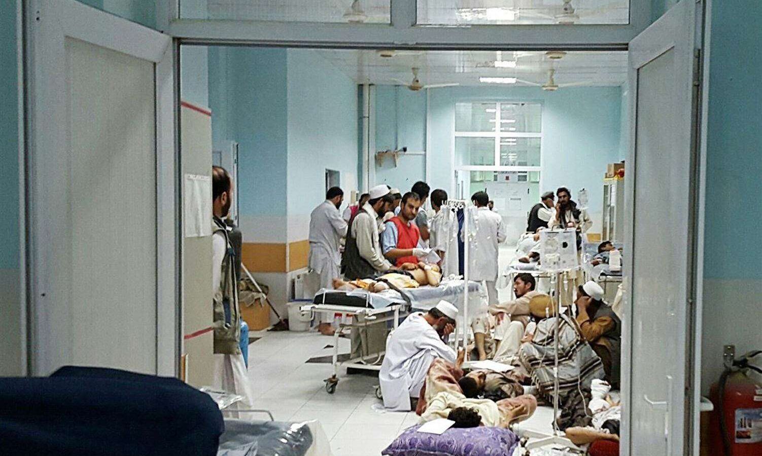 Afghan MSF medical personnel treat civilians injured following an offensive against Taliban militants by Afghan and coalition forces at the MSF hospital in Kunduz.