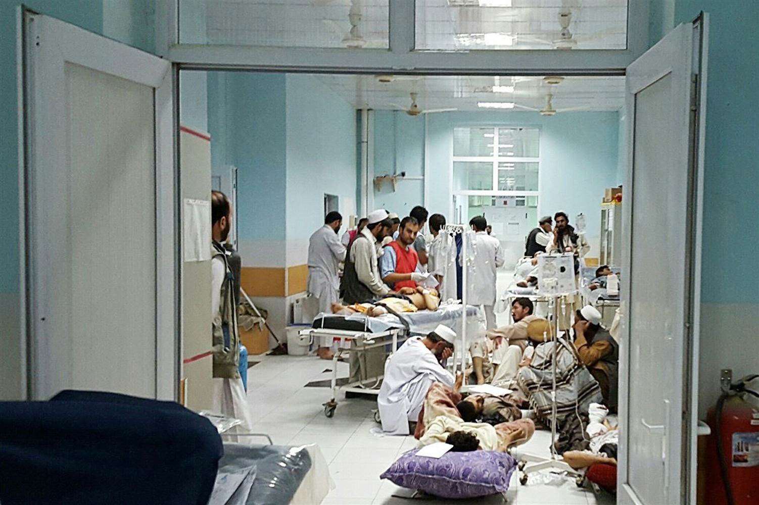 Afghan MSF medical personnel treat civilians injured following an offensive against Taliban militants by Afghan and coalition forces at the MSF hospital in Kunduz. 