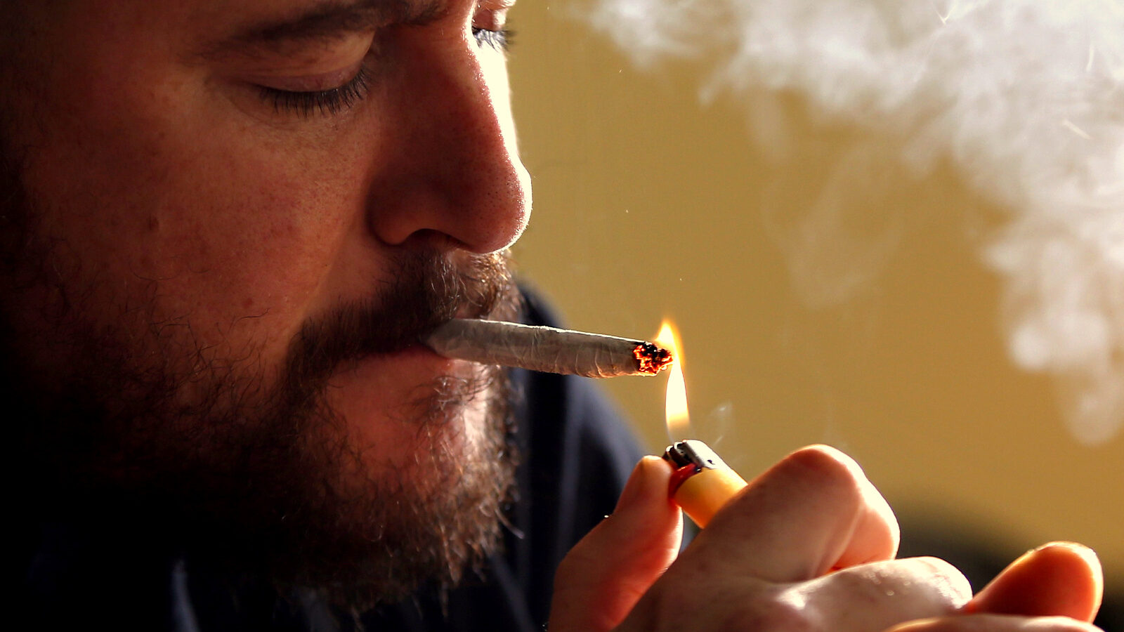 Former U.S. Marine Sgt. Ryan Begin smokes medical marijuana at his home in Belfast, Maine. Begin had endured 35 surgeries after having his right elbow blown off by a roadside bomb in 2004. He is a proponent of legalizing pot for recreational use and allowing individual citizens the right to grow six plants. (AP Photo/Robert F. Bukaty)