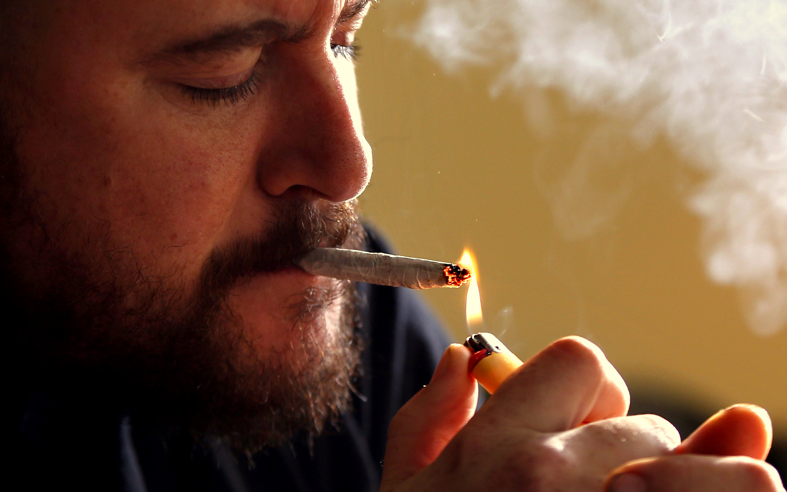 Former U.S. Marine Sgt. Ryan Begin smokes medical marijuana at his home in Belfast, Maine. Begin had endured 35 surgeries after having his right elbow blown off by a roadside bomb in 2004. He is a proponent of legalizing pot for recreational use and allowing individual citizens the right to grow six plants. (AP Photo/Robert F. Bukaty)