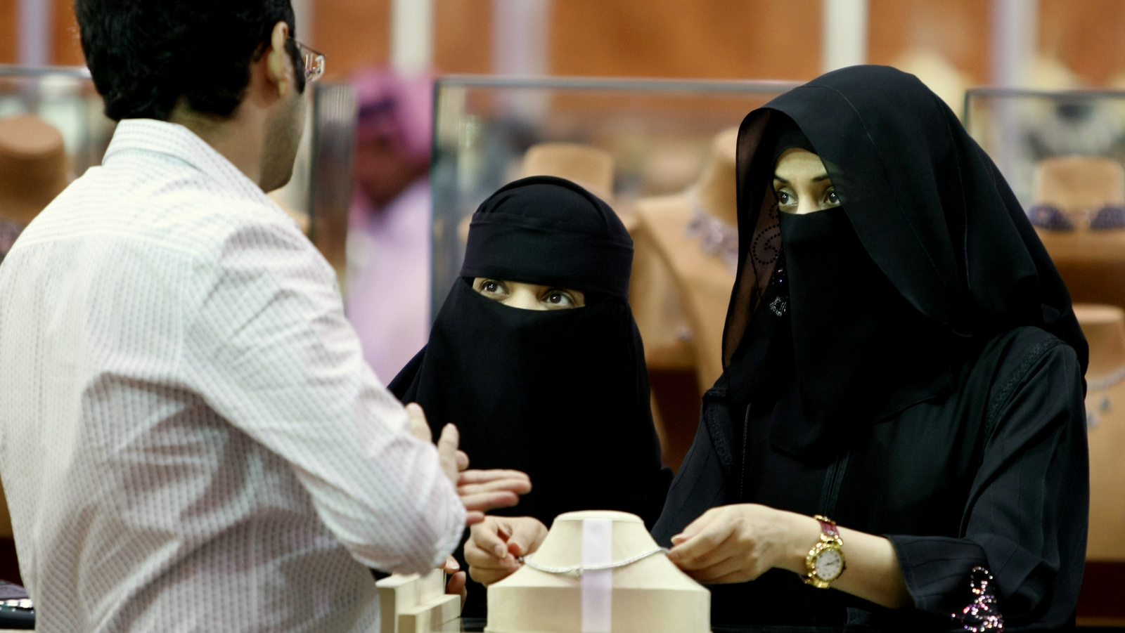 Saudi women look at jewelry at a gold fair in Riyadh, Saudi Arabia. Human rights group Amnesty International says Saudi authorities have use an iron grip to consolidate power and have unleashed a ruthless campaign of persecution against peaceful activists to silence criticism of the state. (AP Photo/Hassan Ammar)