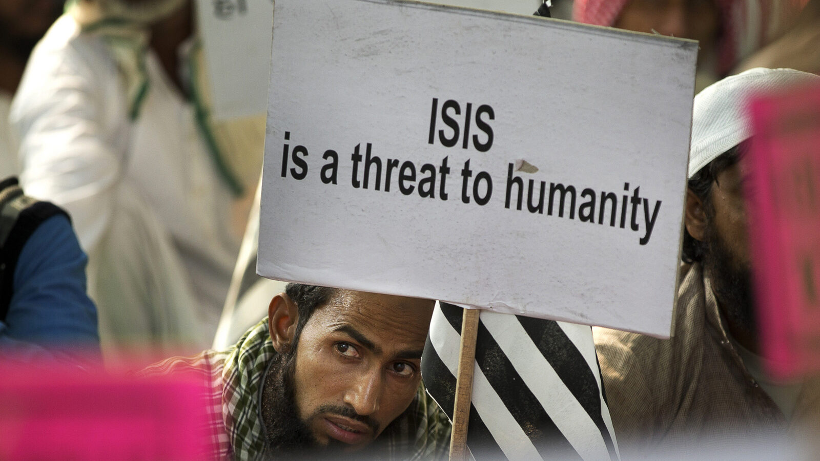 An Indian Muslim man holds a banner during a protest against ISIS, an Islamic State group, and Friday's Paris attacks, in New Delhi, India, Wednesday, Nov. 18, 2015. (AP Photo/Manish Swarup)