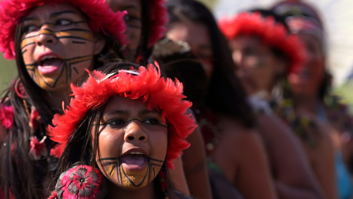 Brazilian Pataxo women take part in a ritual dance during a protest against a proposed constitutional amendment that would put the demarcation of indigenous lands into the hands of the Congress, in front of the Brazil’s National Congress, in Brasilia, Brazil, Tuesday, Nov. 10, 2015. A lower house commission has approved the proposal but it must make its way through the Senate, and be signed by President Dilma Rousseff to become law. (AP Photo/Eraldo Peres)