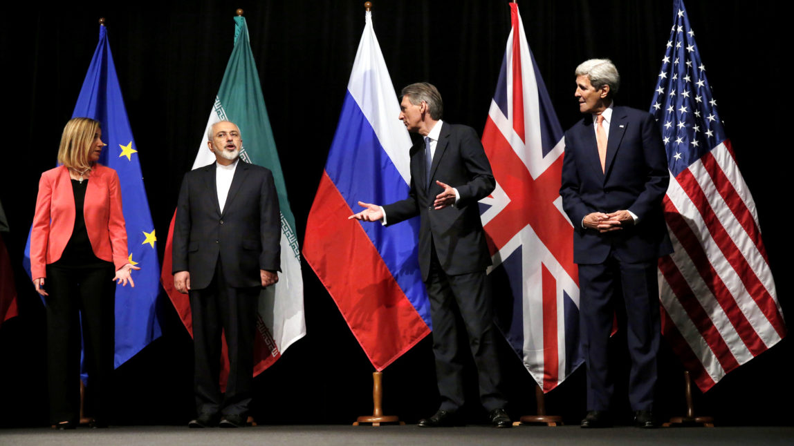 British Foreign Secretary Philip Hammond, second right, U.S. Secretary of State John Kerry, right, and European Union High Representative for Foreign Affairs and Security Policy Federica Mogherini, left, talk to Iranian Foreign Minister Mohammad Javad Zarif as the wait for Russian Foreign Minister Sergey Lavrov, not pictured, for a group picture at the Vienna International Center in Vienna, Austria. Iran sits down with the United States, Russia, Europeans and key Arab states for the first time since the Syrian civil war began to discuss the future of the war-torn country. It will also break ground by bringing President Bashar Assad’s main supporter, Iran, to the same table as its regional rivals, including Turkey and Saudi Arabia, who have been backing many of the insurgent groups. (Carlos Barria, Pool Photo via AP, File)
