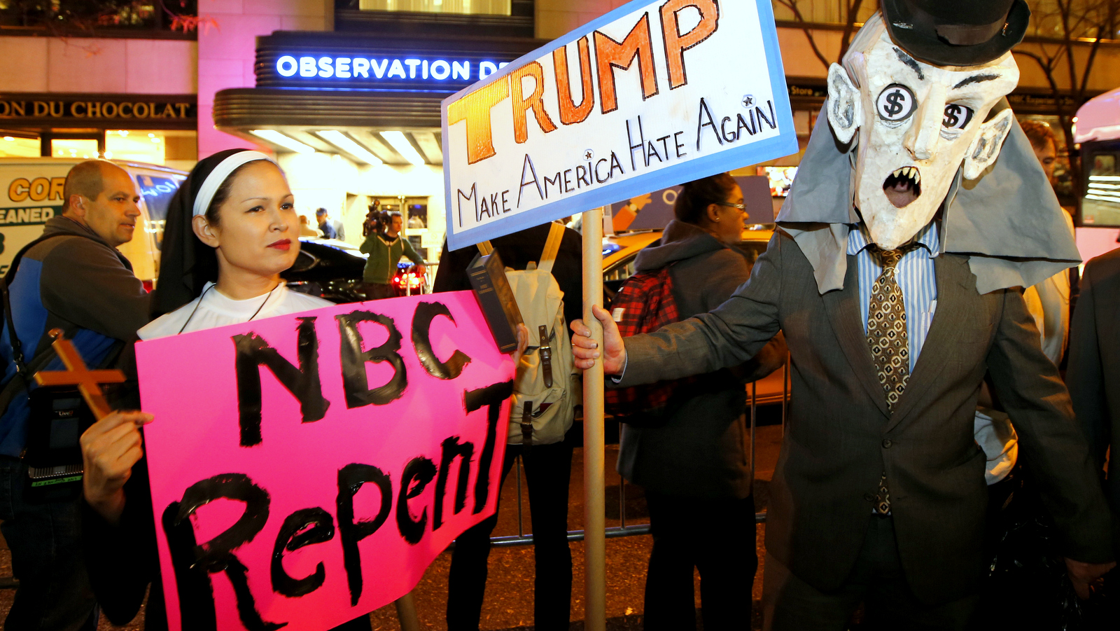 Protesters opposed to the appearance of Republican presidential candidate Donald Trump as a guest host on this weekend's "Saturday Night Live," demonstrate in front of NBC Studios where the television show is taped and broadcast, Wednesday, Nov. 4, 2015, in New York. (AP Photo/Kathy Willens)