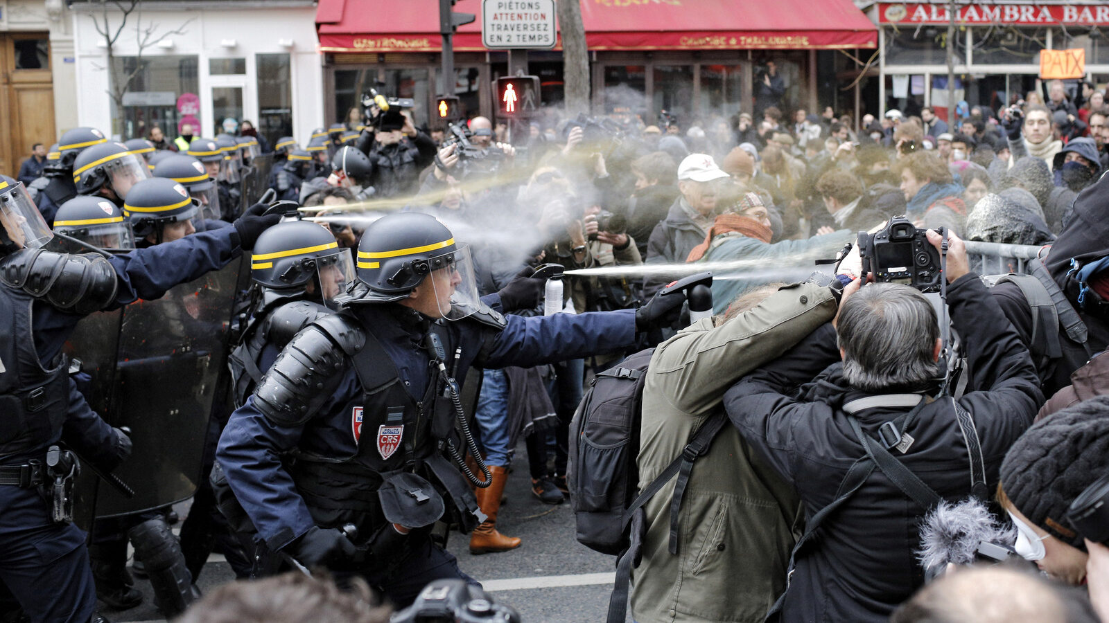 Policemen fight with activists during a protest ahead of the 2015 Paris Climate Conference at the place de la Republique, in Paris, Sunday, Nov. 29, 2015. More than 140 world leaders are gathering around Paris for high-stakes climate talks that start Monday, and activists are holding marches and protests around the world to urge them to reach a strong agreement to slow global warming. (AP Photo/Laurent Cipriani)