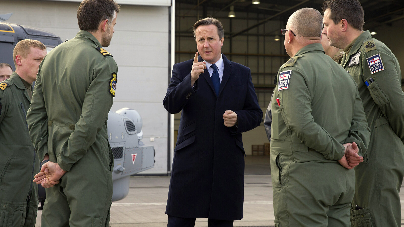 British Prime Minister David Cameron, centre, talks with Royal Navy personnel during his visit to Royal Air Force station RAF Northolt, in west London on Monday Nov. 23, 2015. (Justin Tallis, Pool/AP)