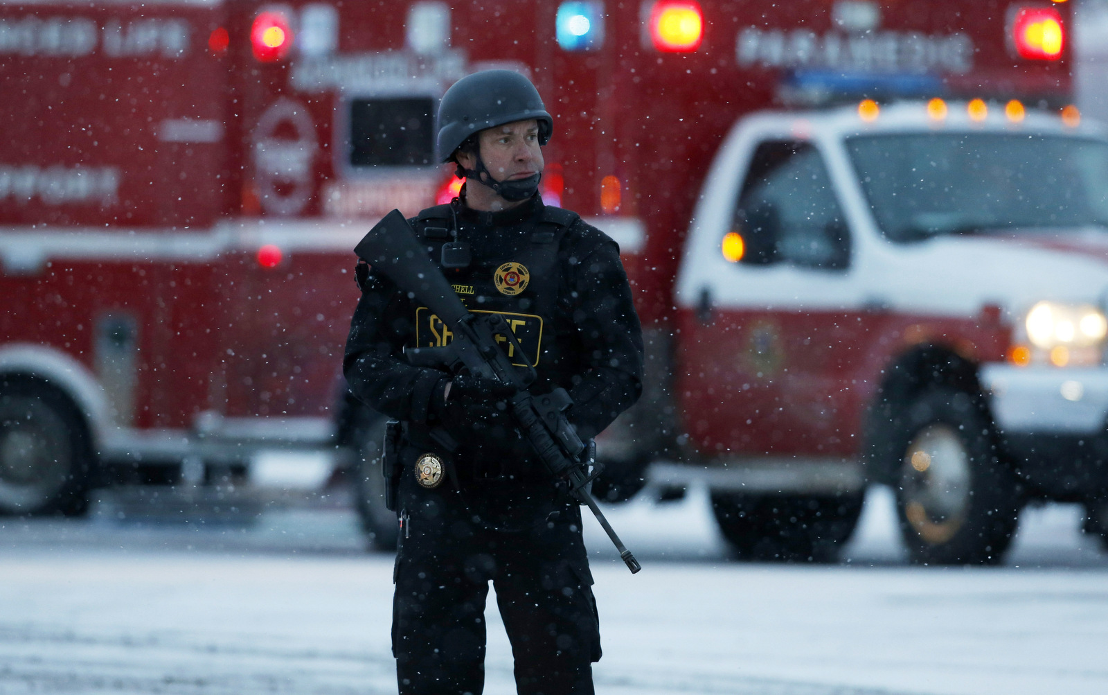 An officer stands guard near a Planned Parenthood clinic Friday, Nov. 27, 2015, in Colorado Springs, Colo. A gunman opened fire at the clinic on Friday, authorities said, wounding multiple people. (AP Photo/David Zalubowski)