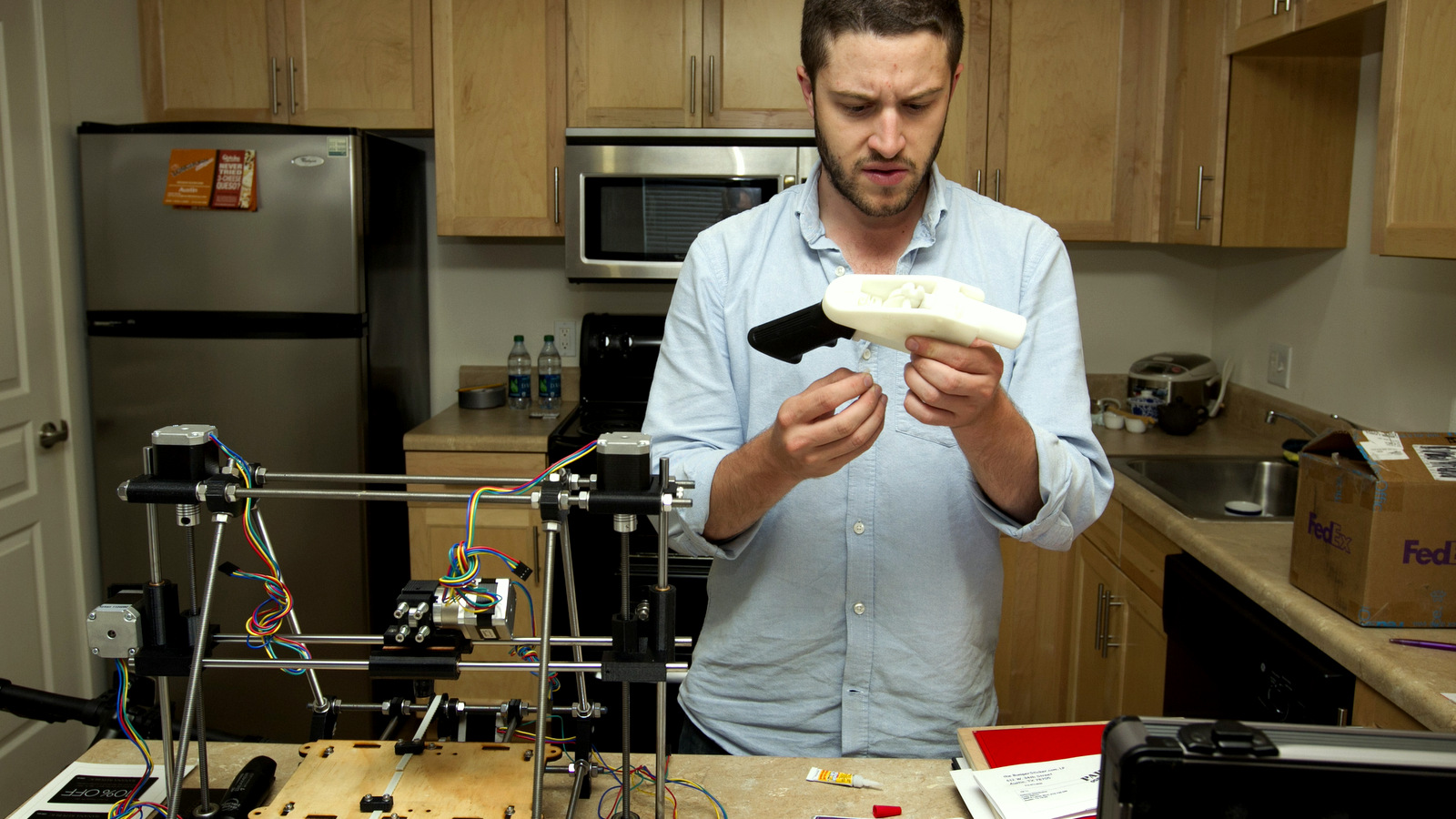 Cody Wilson works on the first completely 3D-printed handgun, The Liberator, at his home in Austin on Friday May 10, 2013. (AP Photo/Austin American Statesman, Jay Janner) 