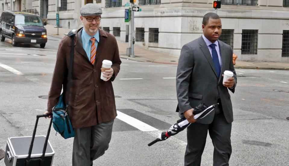 In this Dec. 2, 2015, file photo, Baltimore City police officer William Porter, right, one of six Baltimore police officers charged with the death of Freddie Gray, walks to the courthouse with one of his attorneys in Baltimore. Porter faces manslaughter, assault, misconduct in office and reckless endangerment charges. (Kevin Richardson/The Baltimore Sun via AP)