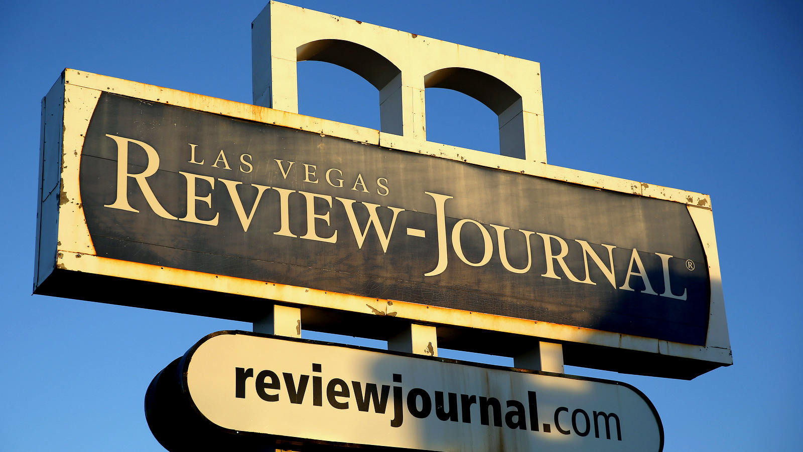 A sign for the Las Vegas Review-Journal is seen Thursday, Dec. 17, 2015, in Las Vegas. The family of billionaire casino mogul and GOP kingmaker Sheldon Adelson confirmed in a statement to the Las Vegas Review-Journal that they are the new owners of Nevada's largest newspaper, ending a week of speculation and demands by staff and politicians to know the identity of the new boss. (AP Photo/John Locher)