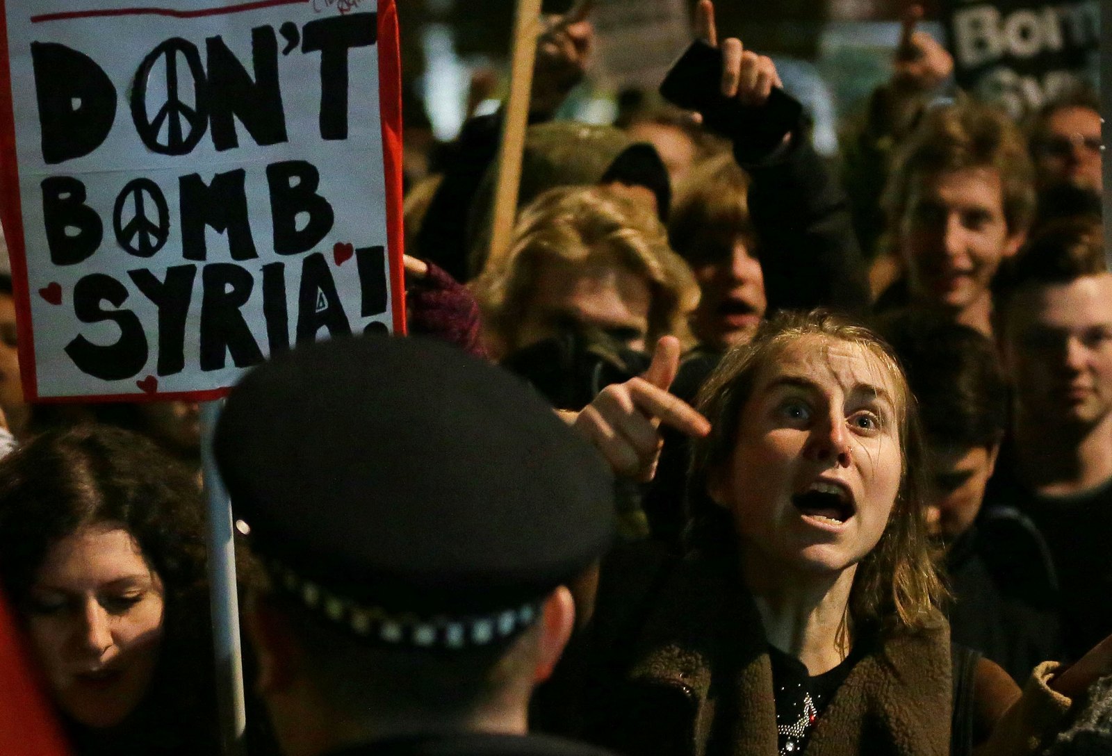 Protesters react outside the Houses of Parliament, in London, Wednesday, Dec. 2, 2015 after UK lawmakers voted 397-223 to launch airstrikes against in Syria. (AP Photo/Tim Ireland)