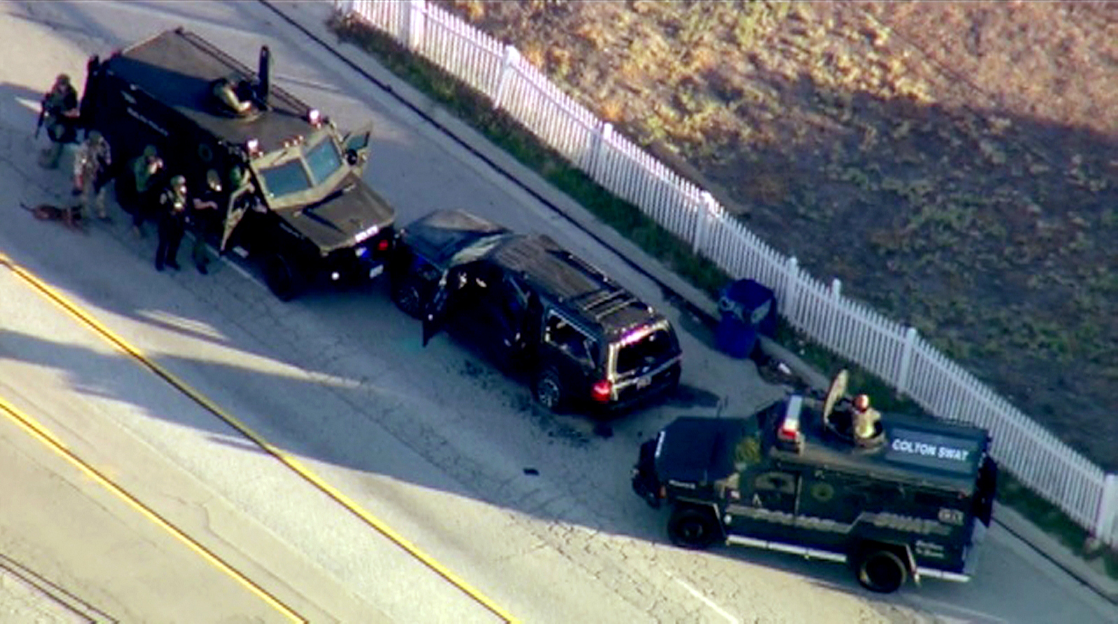 In this image taken from video, armored vehicles surround an SUV following a shootout in San Bernardino, Calif., Wednesday, Dec. 2, 2015. The scene followed a military-style attack that killed multiple people and wounded others at a California center that serves people with developmental disabilities, authorities said. (KTTV via AP)