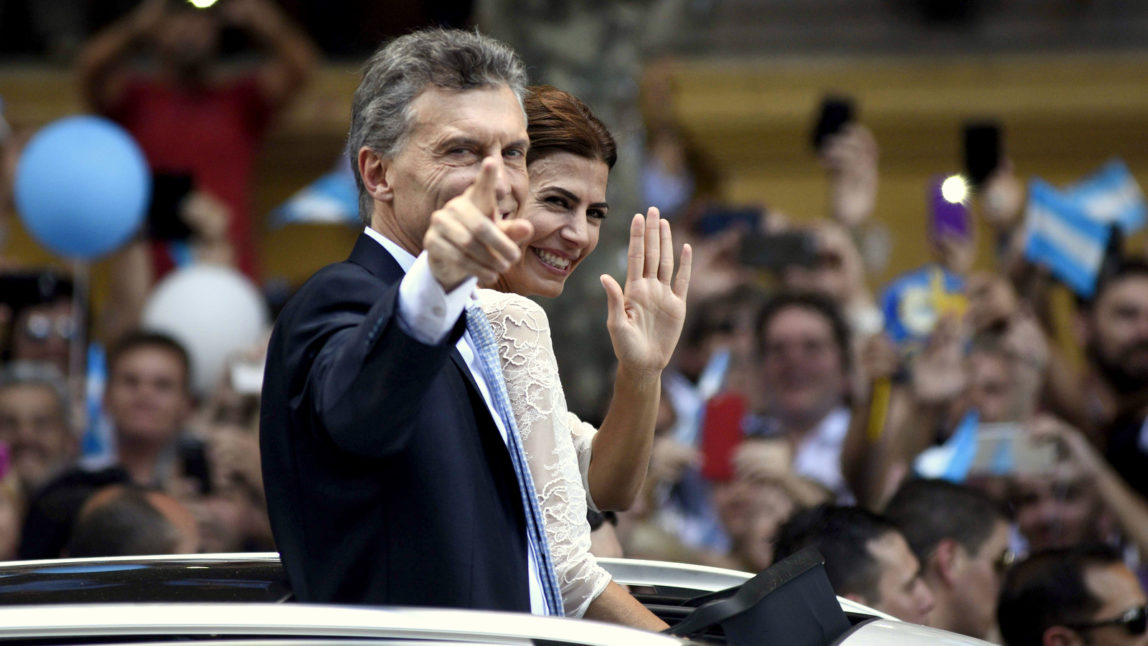 Mauricio Macri and his wife Juliana Awada ride on an open car towards the presidential palace after he was sworn in as Argentina's new president in Buenos Aires, Argentina, Thursday, Dec. 10, 2015. Macri, the former mayor of Buenos Aires who hails from one of Argentina's richest families, took the oath of office in Congress in front of legislators, several Latin American heads of state and other dignitaries, including former Spanish King Juan Carlos I. (AP Photo/Maria Eugenia Cerutti)