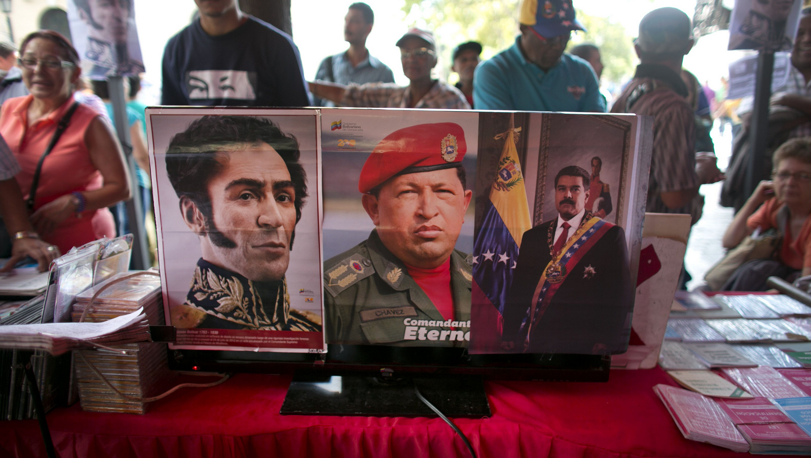 Pictures of Venezuela's independence hero Simon Bolivar, left, Venezuela's late president Hugo Chavez, center, and Venezuela's President Nicolas Maduro are seen pasted on a television screen outside of the National Assembly building during a session in Caracas, Venezuela, Thursday, Dec. 10, 2015. Venezuela's ruling socialist party is set to rush through a series of appointments before the opposition takes over congress next month with promises to revive what it calls a moribund institution. The legislature was expected to name 12 Supreme Court justices Thursday during a final session, filling vacancies left by a group of judges who requested early retirement. (AP Photo/Ariana Cubillos)
