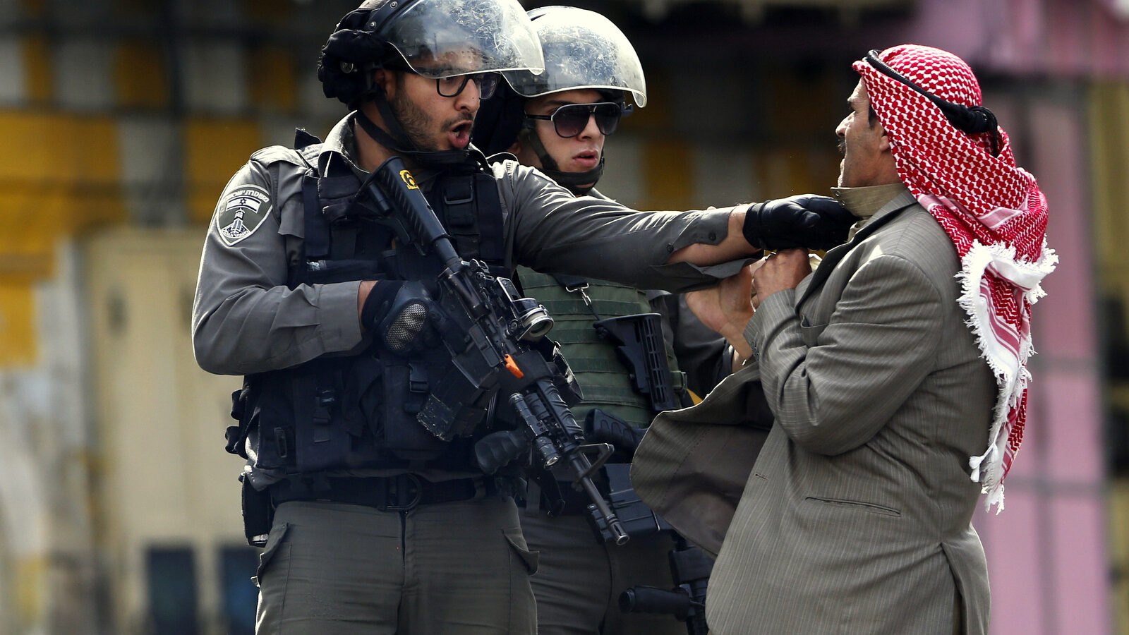 A Palestinian is pushed an Israeli policemen. Saturday, Oct. 10, 2015. (AP Photo/Nasser Shiyoukhi)