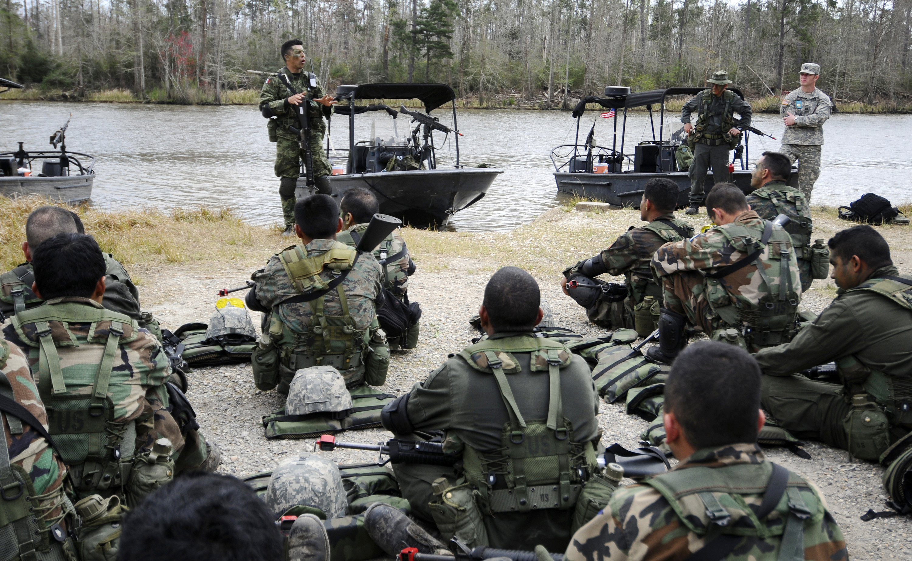 A guest instructor debriefs students from the Western Hemisphere Institute for Security Cooperation and Naval Small Craft Instruction and Technical Training School after a field training exercise. (U.S. Navy photo)