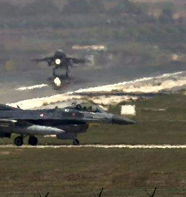 A US Air Force plane takes off as a Turkish Air Force fighter jet taxis at the Incirlik airbase, southern Turkey, Sunday, Sept. 1, 2013. (Photo: AP/Vadim Ghirda)