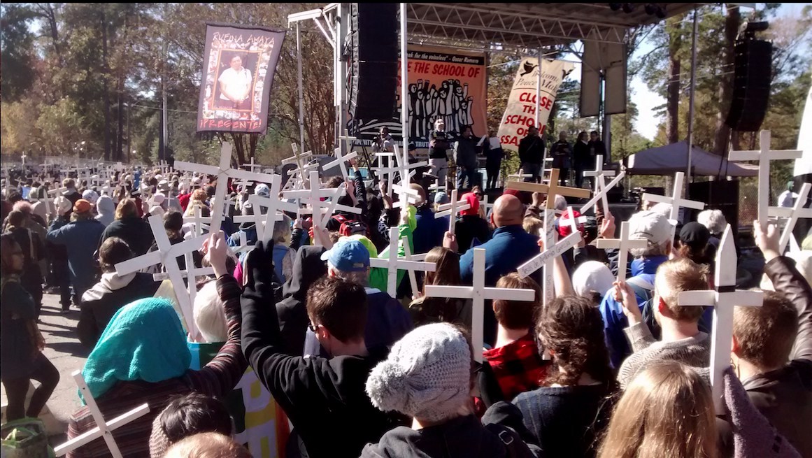 Protesters march to the School of the Americas/Western Hemisphere Institute for Security Cooperation (SOA/WHINSEC).