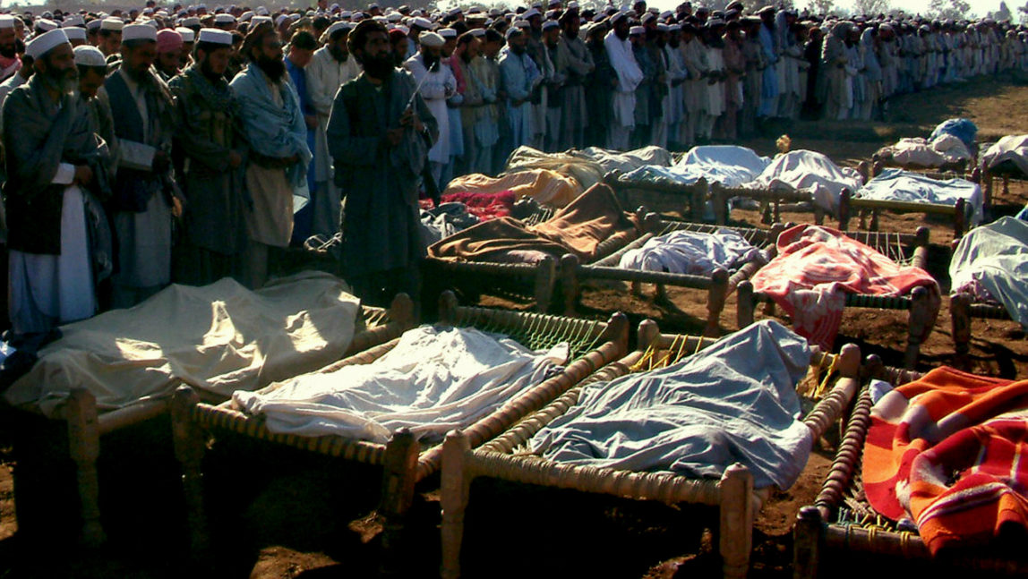 Deputy chief minister of Pakistan's North West Frontier Province offers funeral prayers in front of dead bodies. At least 2,400 people have died in CIA drone strikes in the tribal region of north west Pakistan.