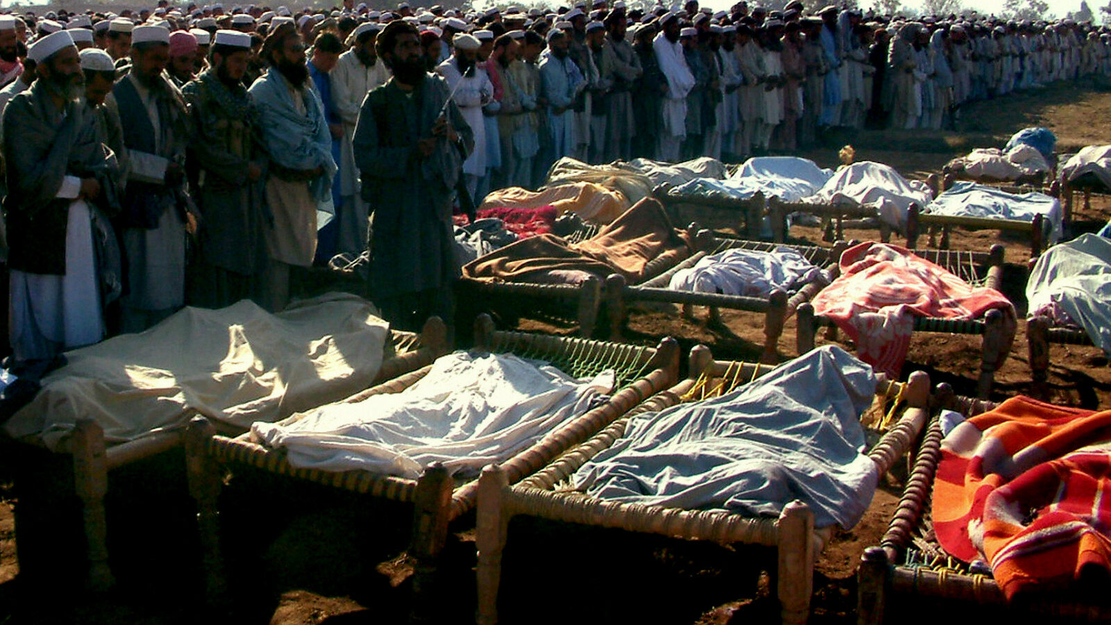 Deputy chief minister of Pakistan's North West Frontier Province offers funeral prayers in front of dead bodies. At least 2,400 people have died in CIA drone strikes in the tribal region of north west Pakistan.