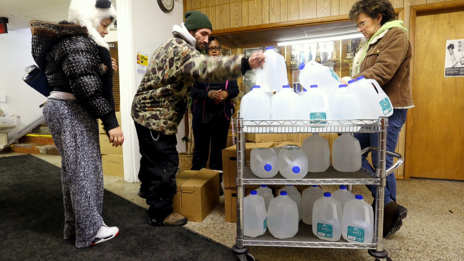 Flint residents receive free water being distributed at the Lincoln Park United Methodist Church in Flint, Mich. Feb. 3, 2015. (AP Photo/Paul Sancya)