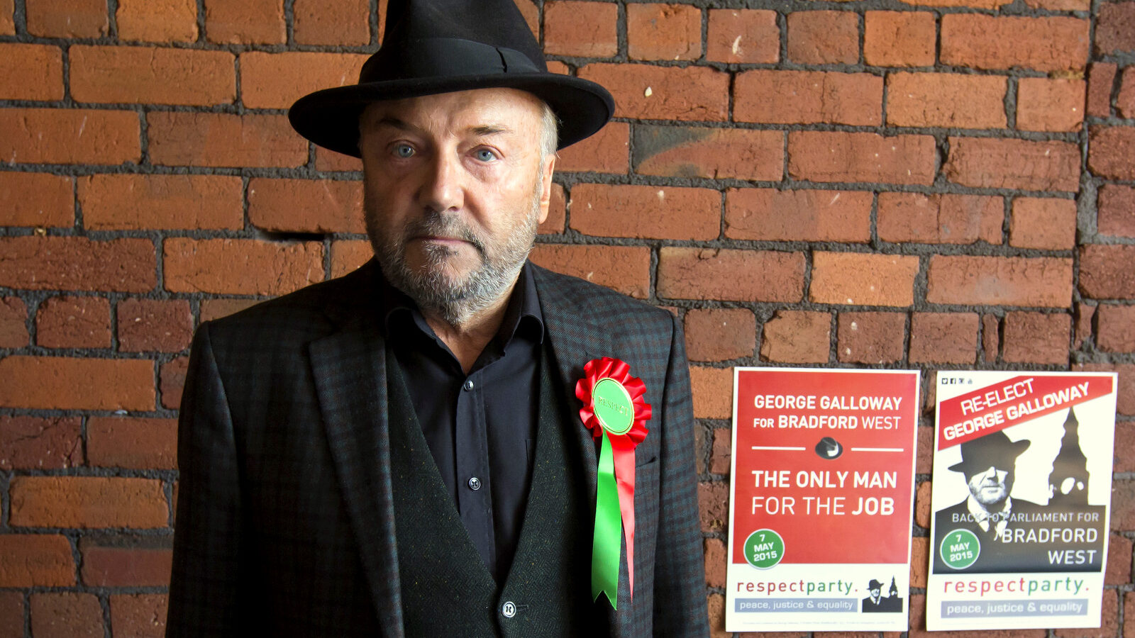 Respect Party Leader George Galloway poses for a picture after an interview at his offices in the constituency of Bradford West, in Bradford, England. (AP Photo/Jon Super)