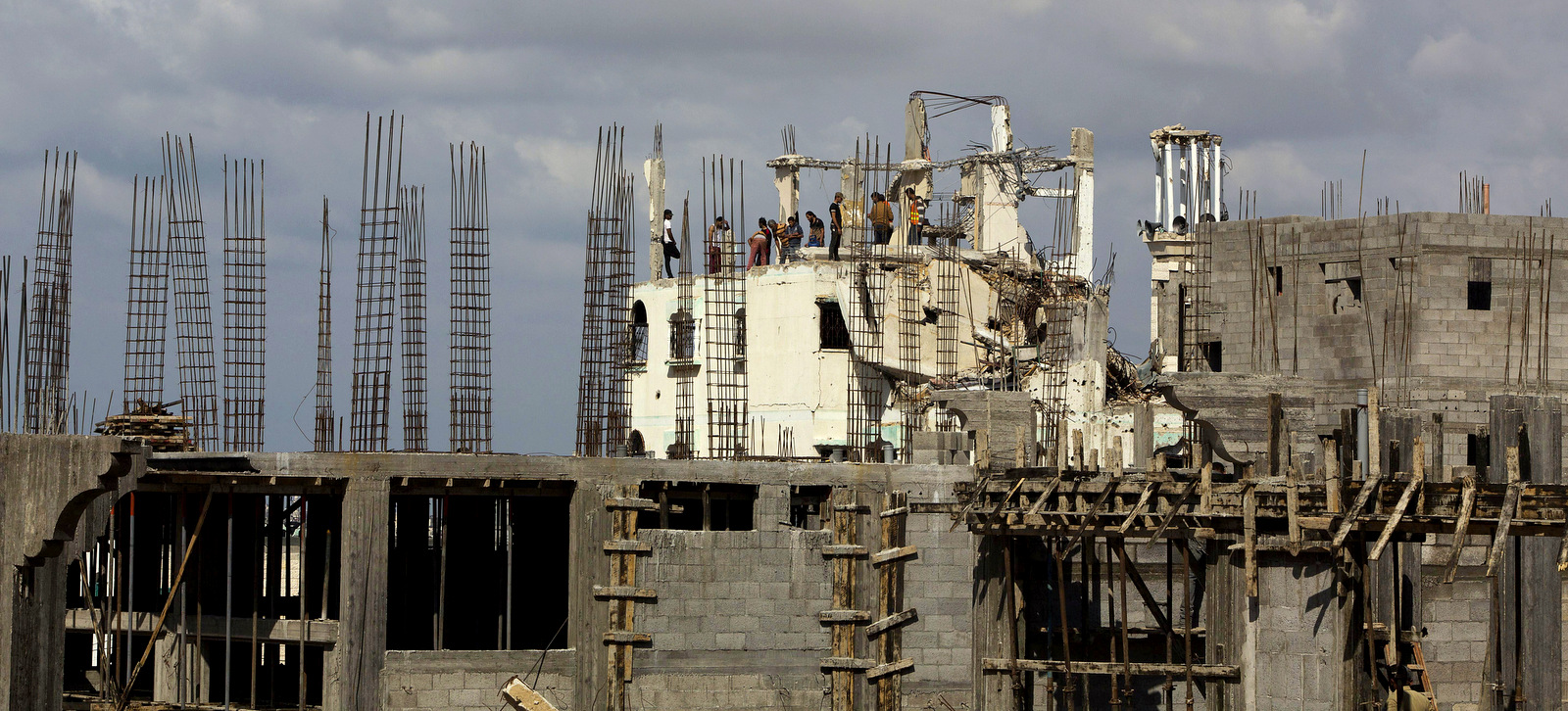 Palestinians work on rebuilding a home destroyed during last summer's Israeli assault on Gaza City. (AP Photo/Adel Hana)