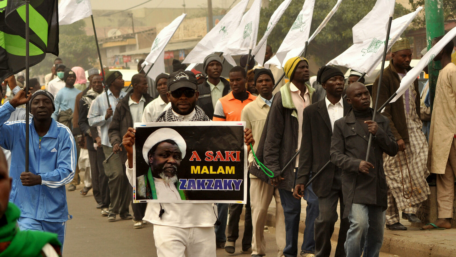 Nigeria Shiite Muslims hold religious flags and banners in a procession celebrating Prophet Muhammad’s birthday and also demanding the release of Shiite leader Ibraheem Zakzaky, on posters, in Kano, Nigeria, Thursday, Dec. 24, 2015. The demonstration was in part provoked after a recent attack by Nigerian soldiers who fired on unarmed Islamic Shiite children with no provocation, killing some hundreds of the minority group in the West African nation, according to a report from Human Rights Watch. (AP Photo/Muhammed Giginyu)