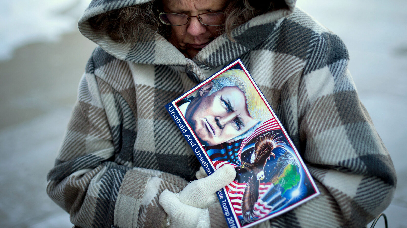 Donald Trump devotee Debbie Heinick shivers while waiting in line to attend a rally for the Republican presidential candidate, Tuesday, Jan. 12, 2016, in Cedar Falls, Iowa. (AP Photo/Jae C. Hong)