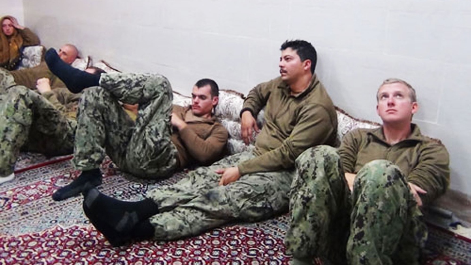An undated picture released by Iran's Revolutionary Guards website shows American sailors sitting in a an undisclosed location in Iran.