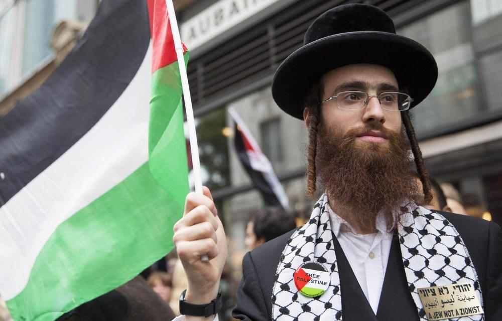 An ultra Orthodox Jew holds a Palestinian flag during a protest against Israel's air strikes on Gaza in London, July 11.