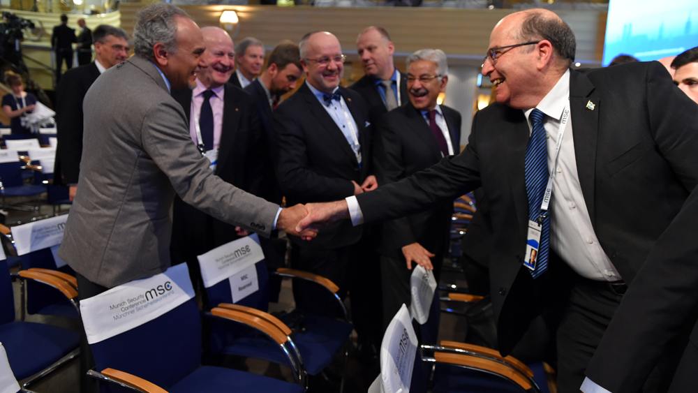 Israeli Defense Minister Yaalon shakes hands with former Saudi intelligence chief, Turki al-Faisal. (Photo: Ariel Harmoni/ Israel Defense Ministry) 