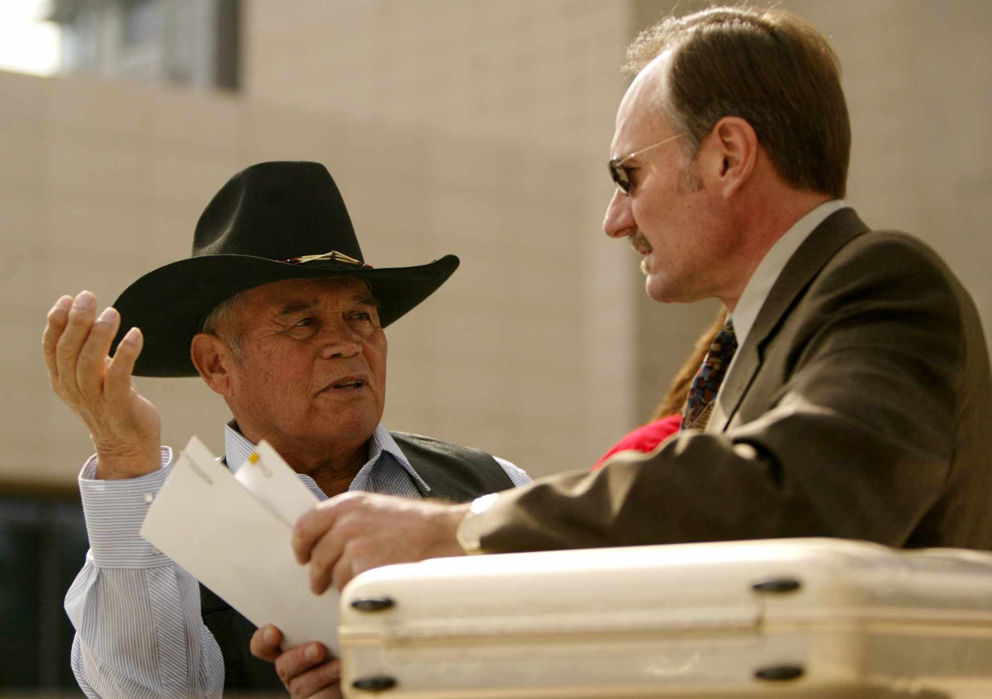 Chief Raymond Yowell of the Western Shoshone Nation, left, confers with tribal attorney Robert Hager, at the U.S. Federal Courhouse in Las Vegas, Friday, March 4, 2005. The tribe filed a lawsuit against the federal government saying a 19th century treaty with the federal government prohibits building a nuclear dump on the Yucca Mountain site that Congress and the Bush administration picked for the repository. (AP Photo/Joe Cavaretta)
